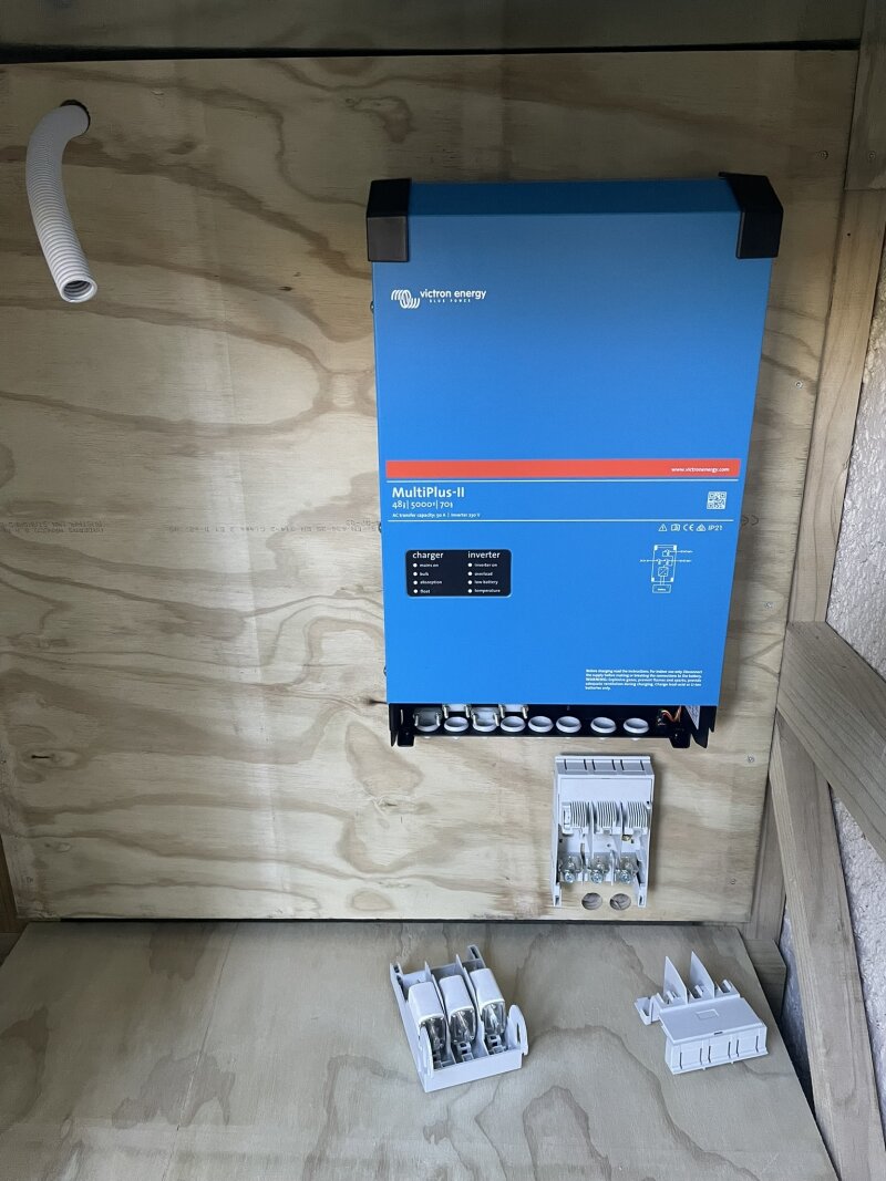Top shelf
reinstalled, with inverter and fused disconnect mounted on back wall.